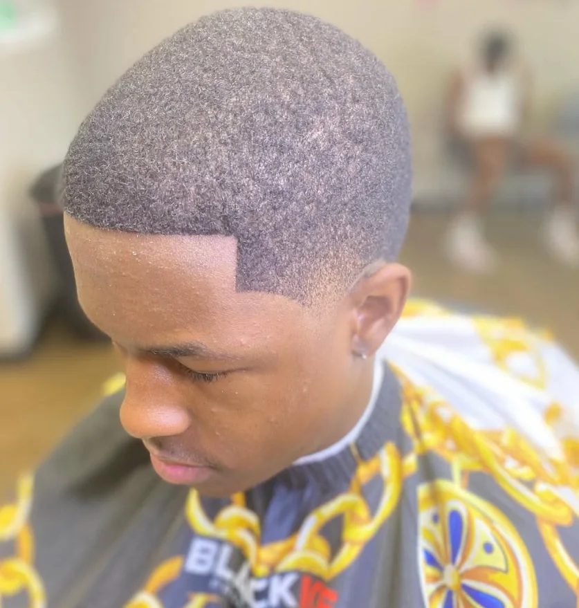 After photo of the same client with a clean tapered haircut
