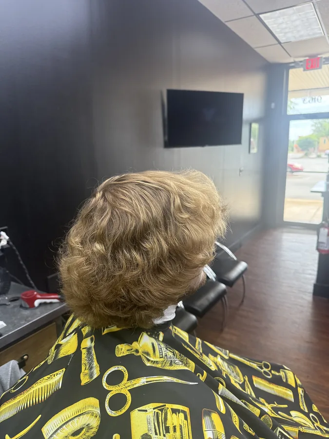 Before photo of a client with an overgrown mop of curly hair