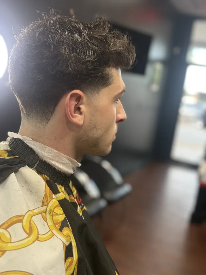 A finished tapered cut on a client, photographed from the side in the shop